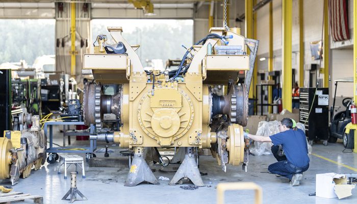 A Carter Cat employee working on a machine rebuild